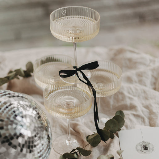 Vier Champagnergläser bilden einen Turm – perfekt für festliche Anlässe.