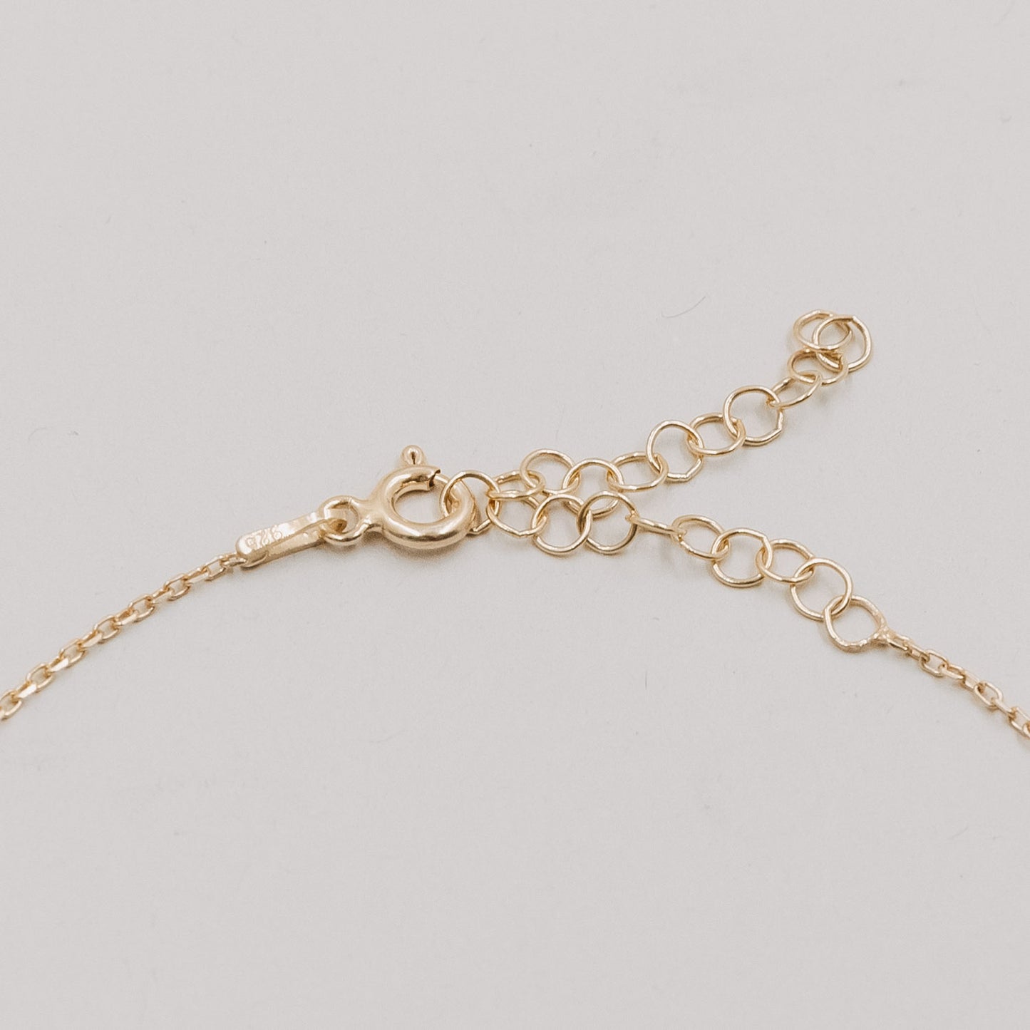 Nahaufnahme des Verschlusses vom Armband Jackie Gold mit Verlängerungskettchen in feiner Gliederoptik.